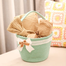Load image into Gallery viewer, Mint green woven basket with a bow 
